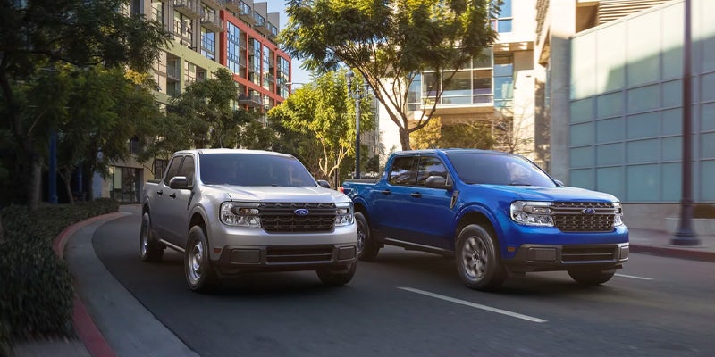 Two 2023 Ford Mavericks alongside one another- one silver and the other blue