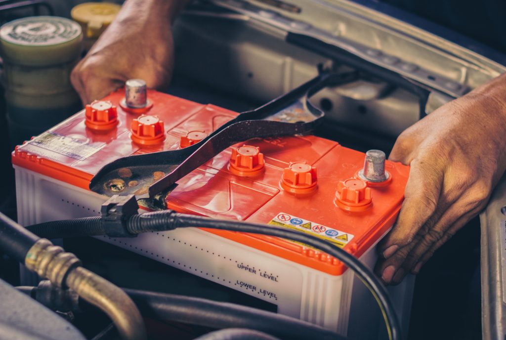 Service technician installing car battery in Salisbury, NC