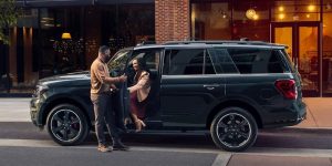 Two people exiting a 2024 Ford Expedition.