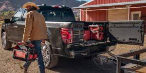 A man unloading tools out of his 2025 Ford F-150.