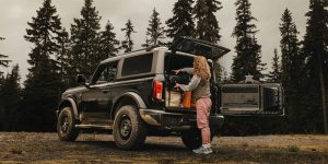 A women packing her 2025 Ford Bronco for a camping trip.