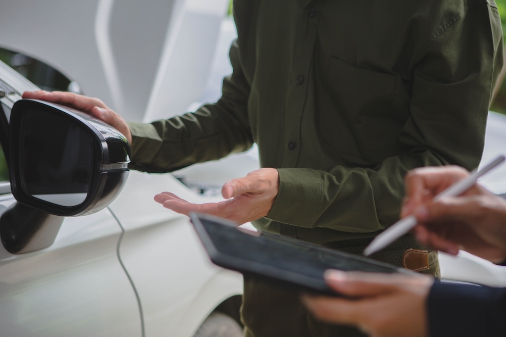 men examining car
