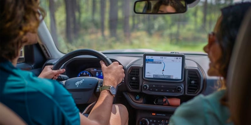 Interior view of the 2024 Ford Bronco Sport with two individuals talking and enjoying the ride