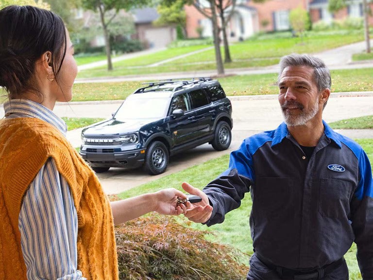 Exterior shot of Customer and Cloninger Ford Technician